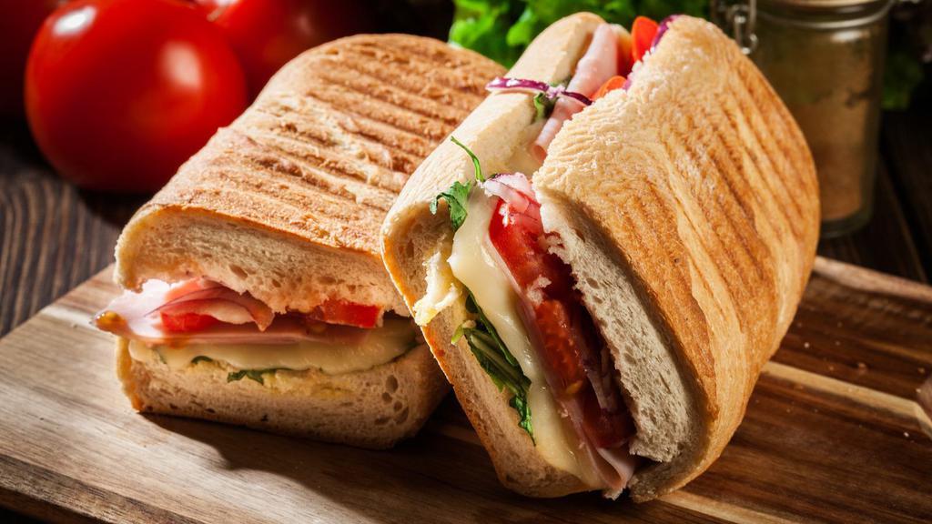 Grilled Chicken Panini · Hot off the panini press! Comes with grilled chicken breast, chopped lettuce, onions, tomatoes, mozzarella cheese, mustard and Mayo.