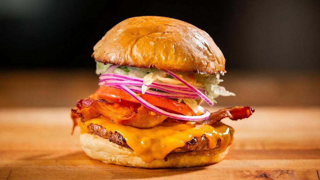 Bacon Cheddar Burger · Bacon, cheddar cheese, & Red Ranch sauce.. Made with lettuce, tomato, onion, & pickles.