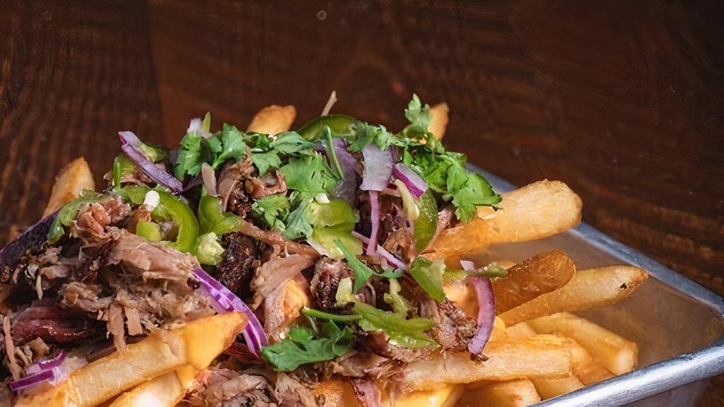 Pork Beer Cheese Fries · Pulled pork, beer cheese sauce, red onions, jalapeños, & cilantro.