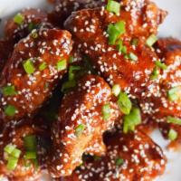 Korean Chicken Wings · Tossed with sesame seeds, scallions, and cilantro and served with a lemon blue cheese dippin...