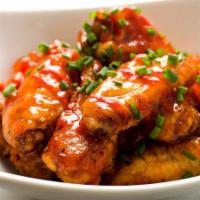 Sriracha Chicken Wings · Tossed with sriracha, butter, lemon zest, and cilantro.