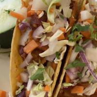 Taco Deli (2pcs) · Vegan. Corn tacos filled with soy chunks, carrots, shredded cabbage and topped with mint and...