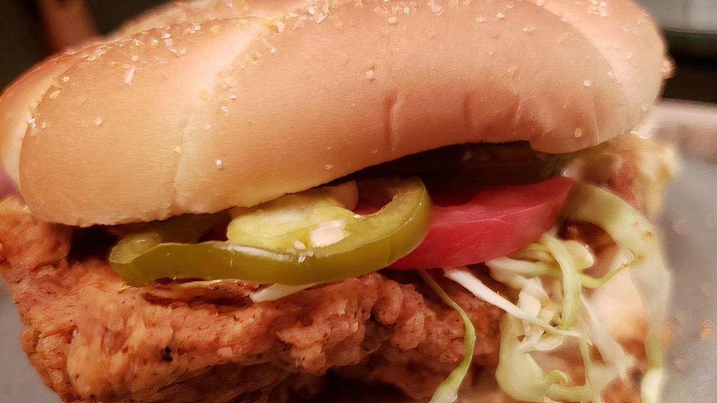 THE SUCIO · Fried Chicken Breast on a Soft Bun, with pickled Jalapenos, Tomato, Red Onions,shredded Cabbage, with a Spicy Chile Crema