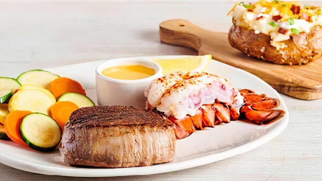 Victoria's Filet® Mignon* & Lobster · A tender and juicy thick-cut filet paired with a steamed lobster tail. Served with a choice of two freshly made sides.