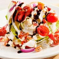 Classic Blue Cheese Wedge Side Salad · A cool, crisp wedge of fresh iceberg lettuce, chopped bacon, grape tomatoes, red onions, Blu...