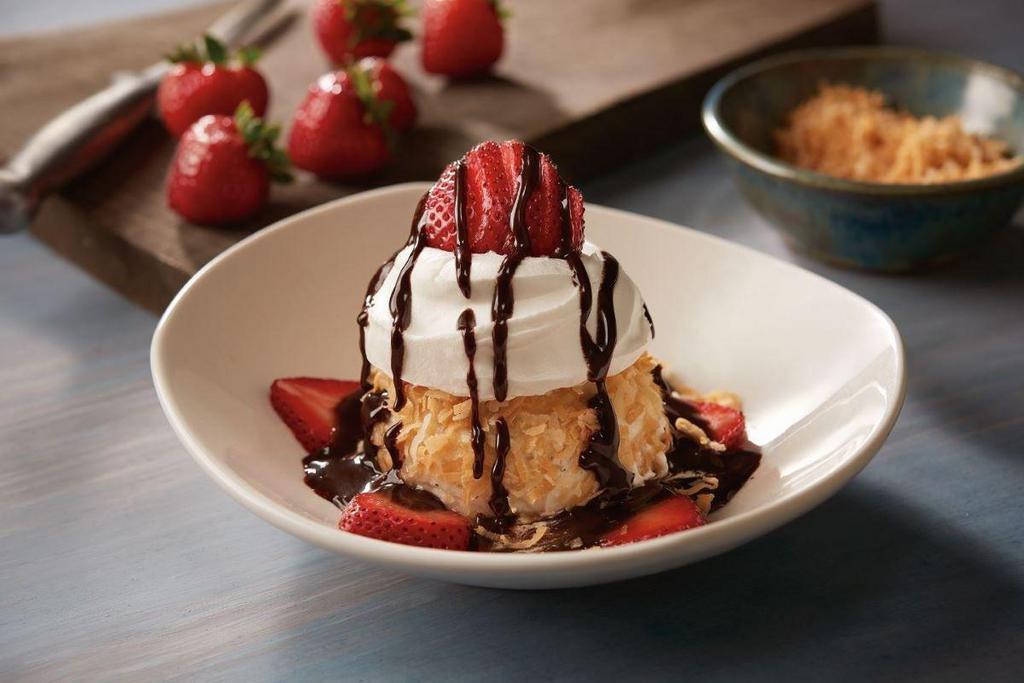 NEW!  Sydney's Sinful Sundae · Creamy vanilla ice cream rolled in toasted coconut and topped with chocolate sauce, whipped cream and a fresh strawberry.