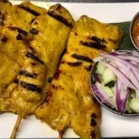 Chicken Sate · Chicken on skewers served with toasted bread, peanut sauce and cucumber salad.