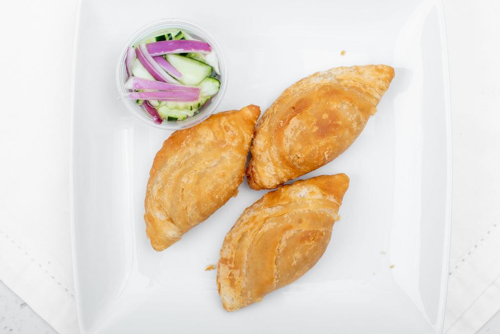 Curry Puffs · Our Thai style crispy pie made with mash potatoes and carrots in yellow curry paste served with cucumber salad.