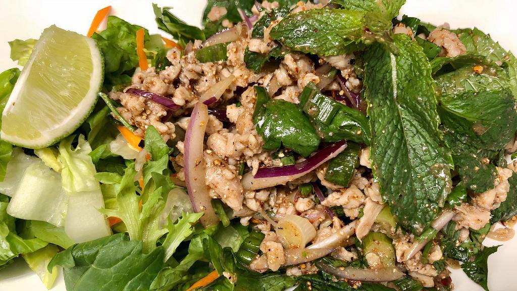 Larb Gai · Thai-Northeastern style salad with minced chicken in chili and lime dressing, rice powder, red onion, scallions and mints leave.