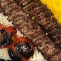 Kubideh with Basmati Rice · Ground beef kabobs seasoned with onions and special spices. Served with grilled tomato and b...