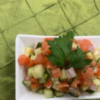 Shirazi Salad · Diced cucumbers, tomatoes and onions dressed in lemon juice, olive oil and dried mint.