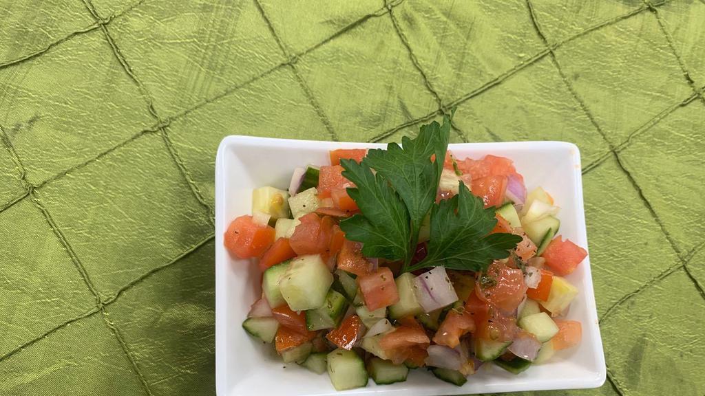 Shirazi Salad · Diced cucumbers, tomatoes and onions dressed in lemon juice, olive oil and dried mint.