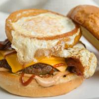 The Hangover · Over medium cage-free egg inside an onion ring, bacon, cheddar cheese, and BBQ sauce.