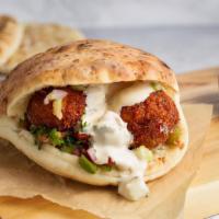 Falafel Pita Sandwich (VG) by Oren's Hummus · By Oren's Hummus. Quick fried falafel, hummus cucumber, tomato, pickels, and tahini in a pit...