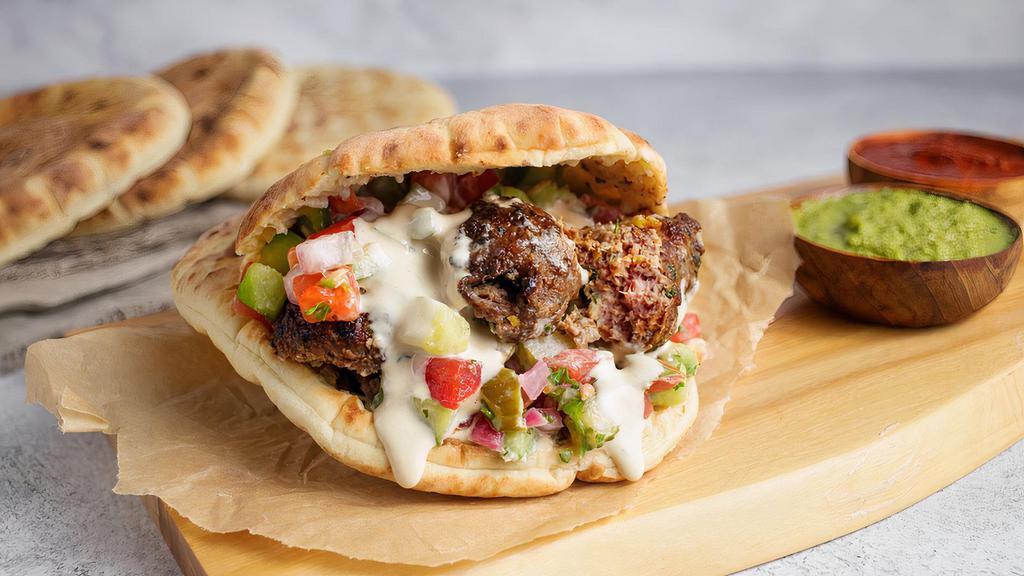 Beef Pita Sandwich by Oren's Hummus · By Oren's Hummus. Chopped beef kebab, hummus, cucumber, tomato, pickles, and tahini in a pita sandwich. Contains gluten, shellfish, and nightshades. We cannot make substitutions.