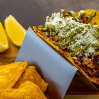 Carnitas Street Taco · Marinated carnitas, grilled jack cheese, house-made guacamole, fresh pico de gallo, avocado ...