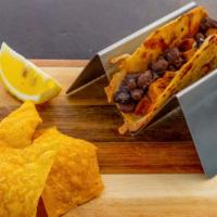 Kid's Steak Taco · Marinated skirt steak, grilled Jack cheese, whole black beans, served on a yellow corn torti...