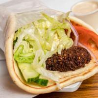 Falafel Wrap · Falafel, Lettuce, Onions, Tomatoes and Pickles with Hummus wrapped inside Pita Bread.