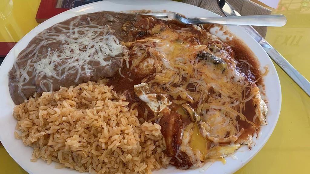 Huevos Rancheros · Eggs, served sunny-side-up over a crispy tortilla, and topped with melted cheddar cheese and homemade tomato sauce. Served with refried beans, rice and corn or flour tortillas.