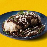 Molé Burrito Burracho · Chicken molé burrito with rice and black beans, topped with molé sauce, and cotija cheese