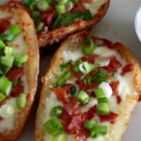 Potato Skins · Five pieces of potato skins with bacon and scallion, served with sour cream.