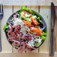 Antipasto Salad · Ham, salami, with green pepper, black olives, onions, tomatoes, and mozzarella cheese over a...