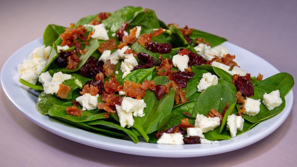Spinach Salad · Baby spinach, crumbled bacon, dried cranberries, crumbled feta cheese, and balsamic vinaigrette dressing.