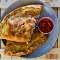 Bacon cheese calzone · Bacon, ground beef, onions, and mozzarella cheese.