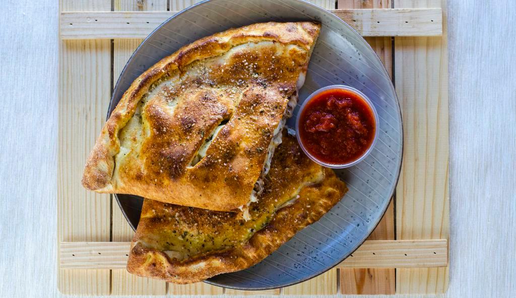 Bacon Cheese Burger Calzone · Ground beef, onions, bacon, ricotta, and mozzarella cheese.