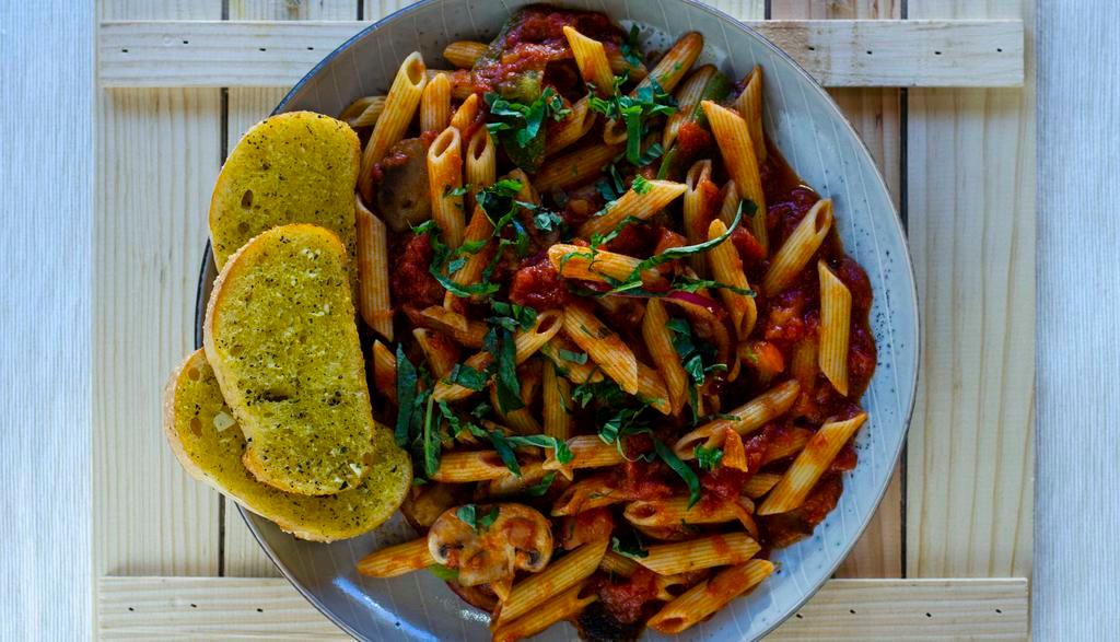 Pasta Primavera · Penne with mushrooms, bell peppers, onion, garlic, basil, and tomatoes in marinara sauce. All pasta dishes are served with garlic bread.