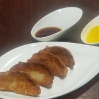 Fried Pot Stickers (4 pieces) | 군만두 · Homemade poached pot stickers stuffed with pork and vegetables.