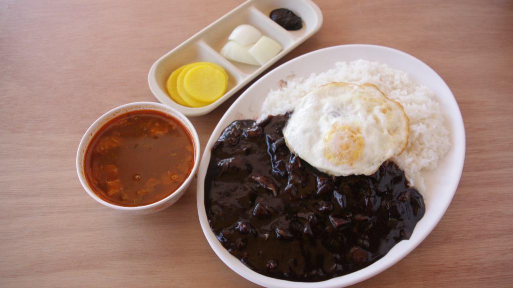 ZaZang Bap (자장밥) · Ground pork and vegetables in black bean sauce over steamed rice served with a fried egg on top.