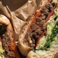 Bulgogi Sandwich · Spicy. Sweet vinegar cucumbers, lettuce, tomatoes, pickles, onions, mayo, and mildly spicy K...