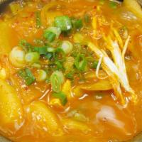 Kimchi Stew · Vegan. Kimchi with tofu, glass noodles, scallions, and sliced rice cakes.