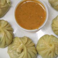 Chicken Momo · Eight homemade and wrapped Nepalese potstickers, filled with chicken, and seasoned with impo...