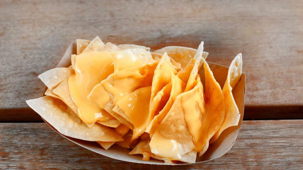 Cheese Nachos · Corn tortilla chips topped with nacho cheese.