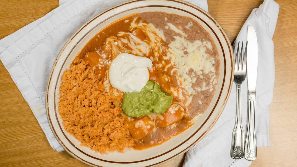 Enchiladas Suizas · 2 corn or flour tortillas filled with you choice of Chicken, Ground beef, Shredded Beef or Cheese and topped with sour cream and guacamole