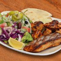 Fish and Chicken Grill Plate · Grilled marinated Salmon fish and Chicken cubes, served with salad, rice, tzatziki sauce, an...