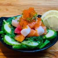 Seafood Sunomono · Assorted fish, tobiko, seaweed salad, and cucumber with poke dressing.