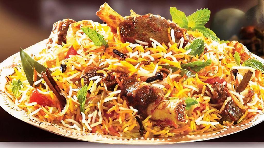 18. Goat Biryani · Basmati fried rice with goat, herbs, and spices.