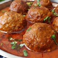 36. Vege Kofta Curry · Three Vege balls in curry sauce, herbs, and spices.