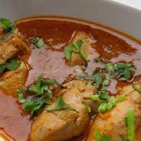 38. Chicken Curry · Chicken in onion, ginger, garlic, tomatoes, herbs, and spices.