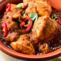 39. Chicken Vindaloo · Chicken curry with potatoes, spicy sauce, herbs, and spices.