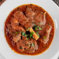 53. Goat Curry · Goat with ginger, garlic, and special blend of spices.