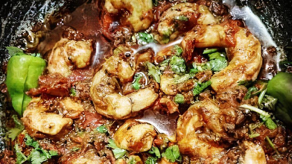 66. Prawns Karahi · Prawns sautéed with tomatoes, bell pepper, and spices in a traditional pan.