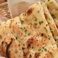 68. Garlic Naan · Soft bread with garlic freshly baked in tandoor.