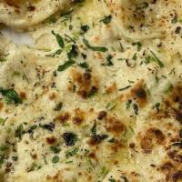 Garlic Naan · Naan baked in tandoor with a topping of garlic and cilantro.