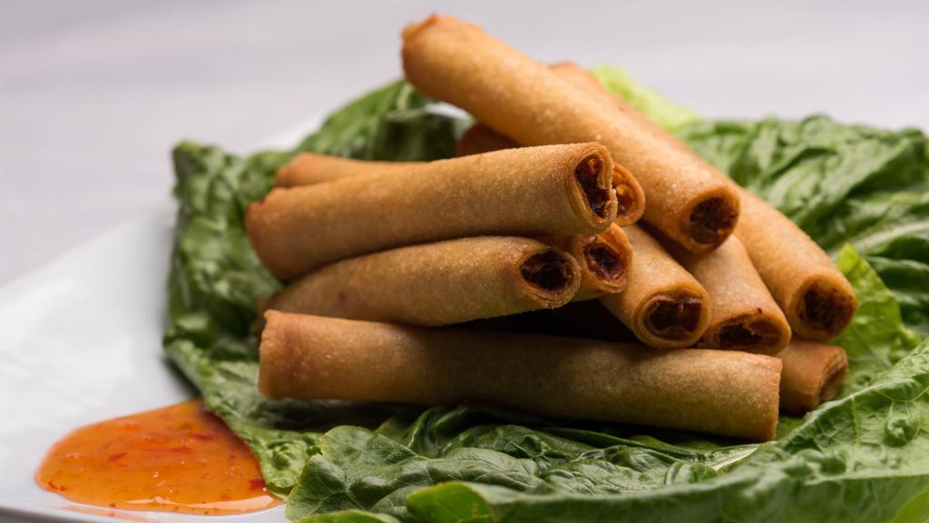 Lumpias (10pc) · A Serving of Our Delicious Fried Pork Lumpias. 
(10 Rolls per order). Paired with a delicious/not spicy sweet-chili sauce.