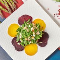 Beet Salad · Roasted golden and red beets, baby arugula, goat cheese, almonds, and citrus-truffle vinaigr...