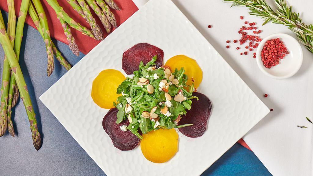 Beet Salad · Roasted golden and red beets, baby arugula, goat cheese, almonds, and citrus-truffle vinaigrette.